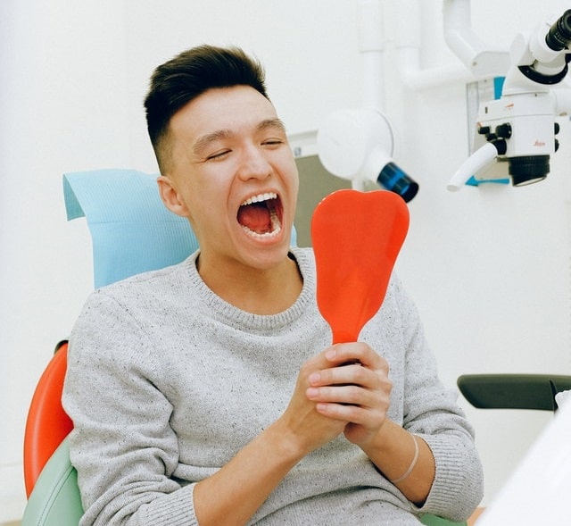 man checks his teeth